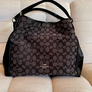 A classic black canvas Coach handbag